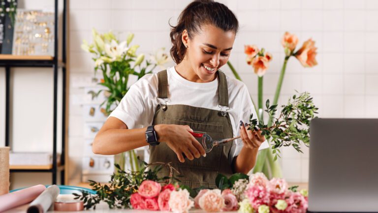 Smiling,Woman,Working,At,Counter